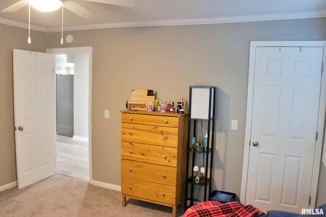 bedroom with ornamental molding, ceiling fan, and light colored carpet