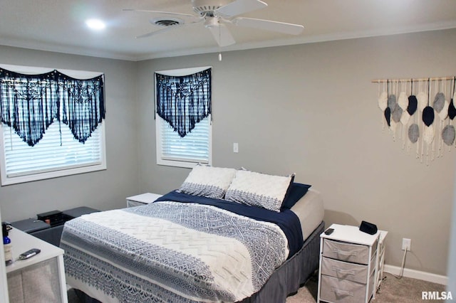 bedroom with carpet floors, crown molding, and ceiling fan