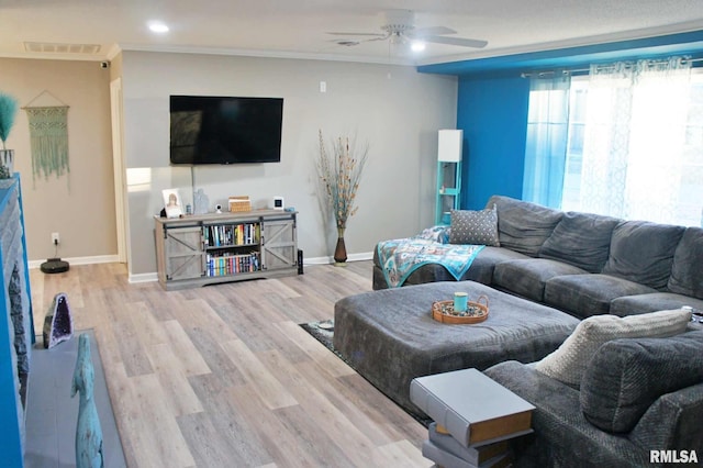 living room featuring light wood-type flooring and ceiling fan