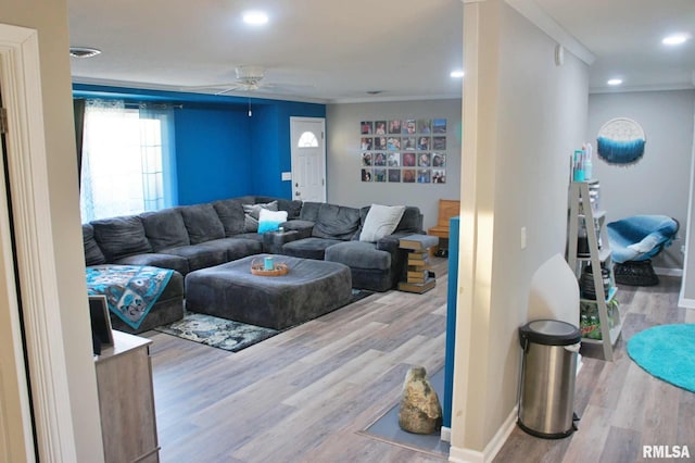 living room with wood-type flooring and ceiling fan