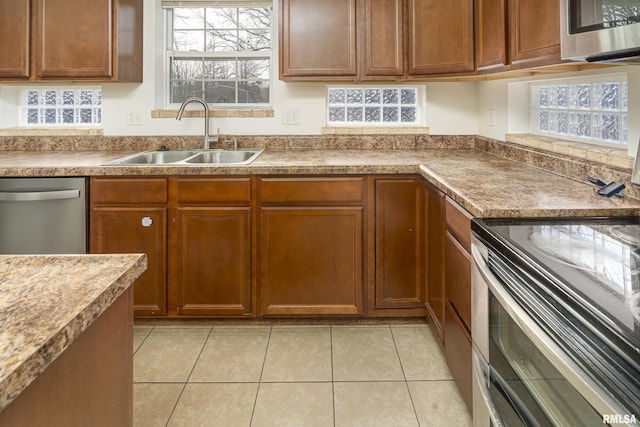 kitchen featuring sink, light tile patterned floors, and appliances with stainless steel finishes