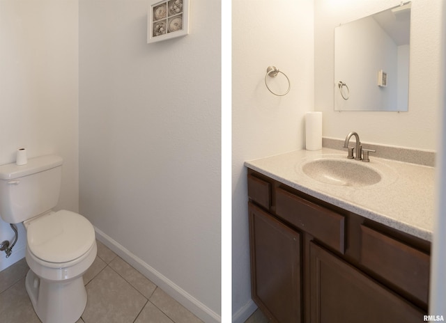 bathroom featuring toilet, tile patterned flooring, and vanity