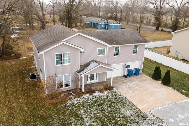 back of house with a garage and cooling unit