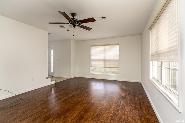 unfurnished room featuring ceiling fan and dark wood-type flooring