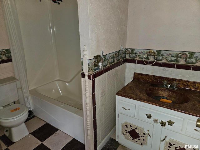 full bathroom featuring vanity, toilet, shower / bathtub combination, and tile walls