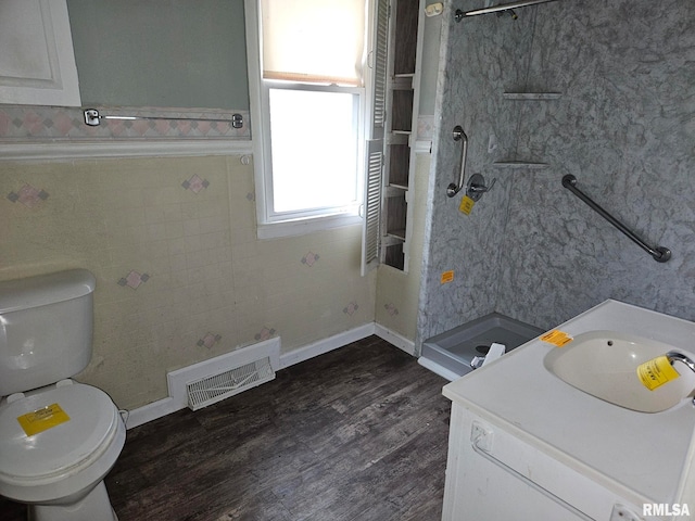 bathroom featuring vanity, toilet, a shower, and hardwood / wood-style floors