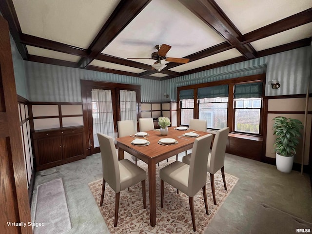 dining area with coffered ceiling, ceiling fan, light colored carpet, and beamed ceiling