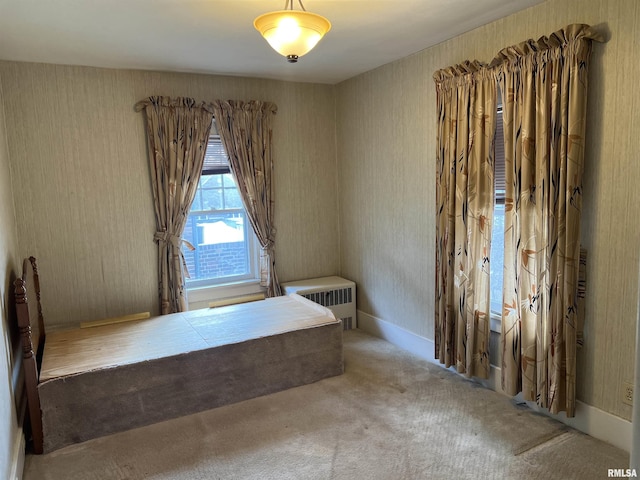 unfurnished bedroom featuring radiator heating unit and carpet