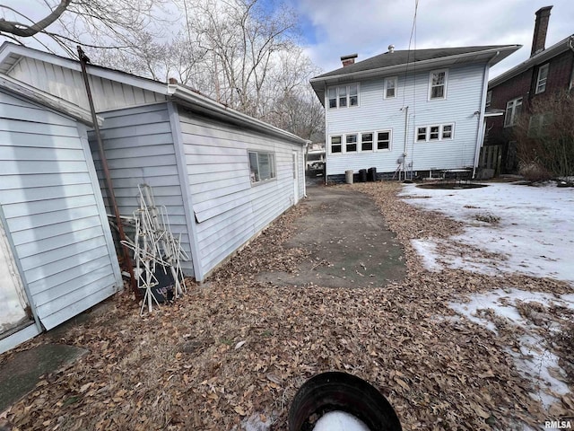 snow covered property with central AC unit