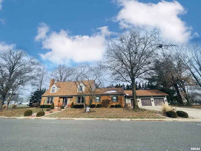 new england style home with a garage