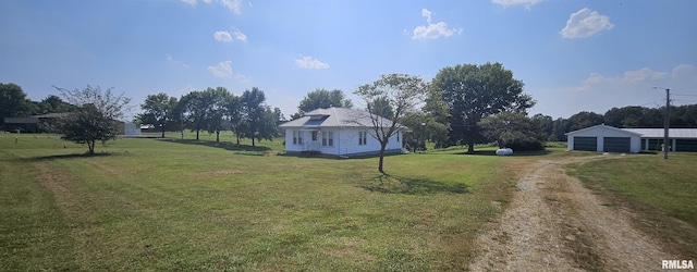 view of yard with an outdoor structure and a garage