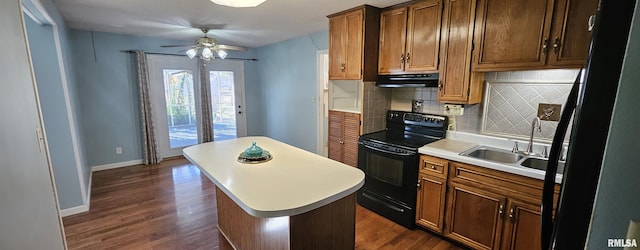 103 David Dr, Mcclure, IL 62957 - kitchen featuring black appliances, ventilation hood, decorative backsplash, light countertops, and dark wood-style floors