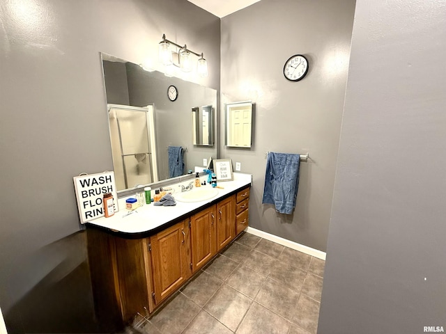 bathroom featuring tile patterned floors, vanity, and a shower with shower door