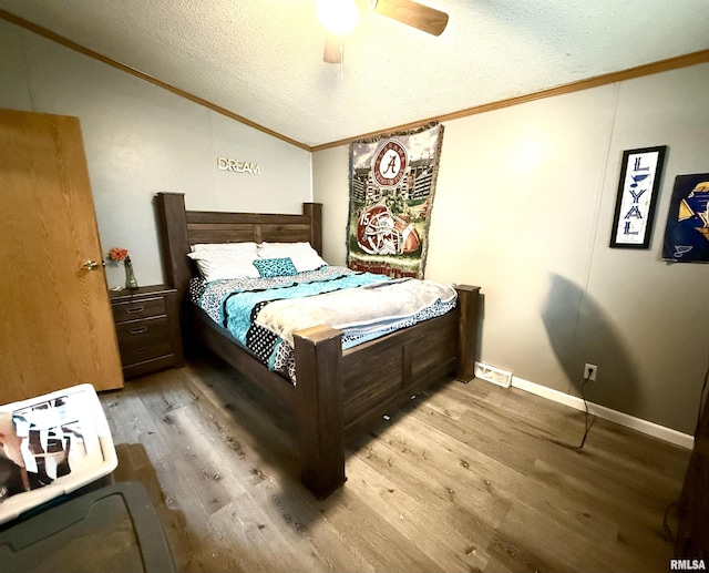 bedroom with crown molding, a textured ceiling, ceiling fan, and light hardwood / wood-style floors