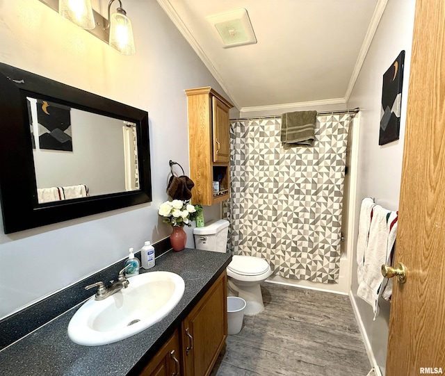 full bathroom featuring vanity, wood-type flooring, ornamental molding, toilet, and shower / bath combo with shower curtain