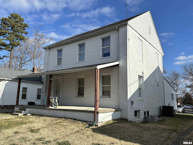 back of house with a lawn, a patio, and central air condition unit