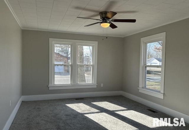 unfurnished room with crown molding, ceiling fan, and dark carpet