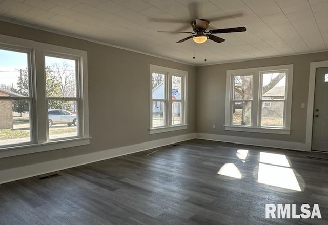 spare room with crown molding, dark hardwood / wood-style floors, and ceiling fan