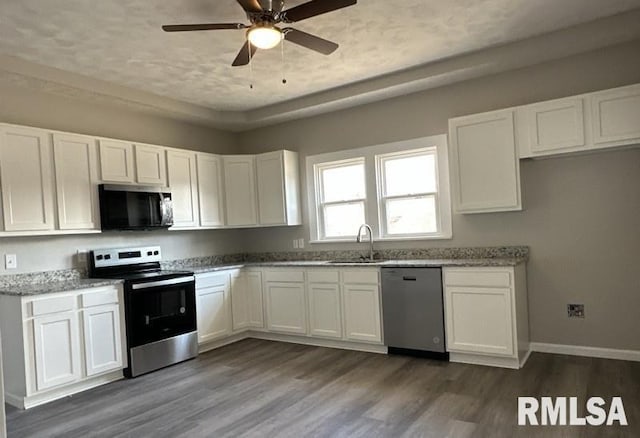 kitchen featuring white cabinetry, sink, light stone countertops, and appliances with stainless steel finishes