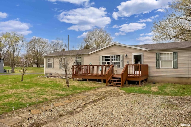 rear view of house with a deck and a lawn