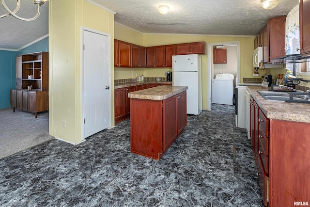 kitchen with lofted ceiling, sink, a center island, white appliances, and washer / clothes dryer