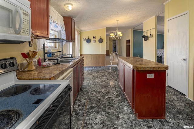 kitchen with sink, a textured ceiling, range with electric stovetop, a kitchen island, and pendant lighting