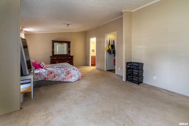 bedroom featuring ensuite bath, ornamental molding, light carpet, and a textured ceiling