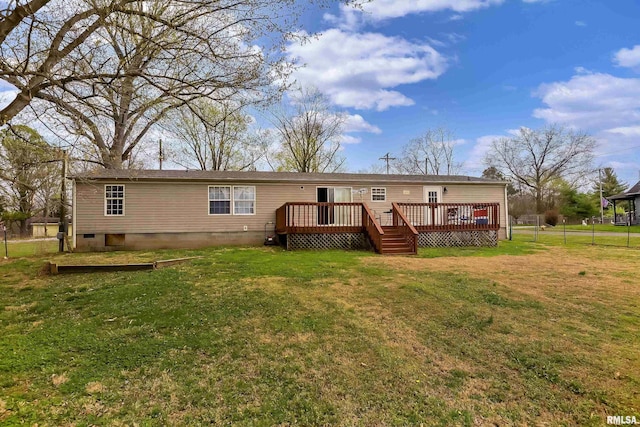 rear view of house featuring a yard and a deck