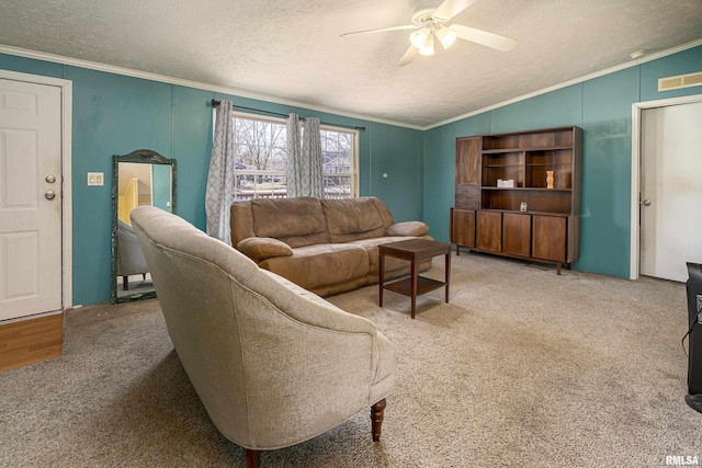 carpeted living room featuring ceiling fan, vaulted ceiling, ornamental molding, and a textured ceiling