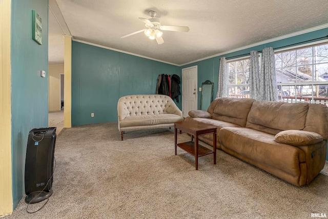 living room with crown molding, ceiling fan, carpet, and a textured ceiling