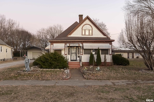 view of front of house featuring an outbuilding, a carport, and a garage