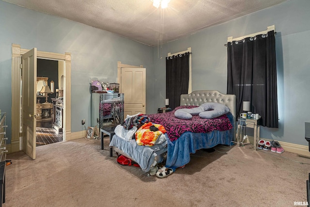 bedroom featuring a textured ceiling and carpet flooring