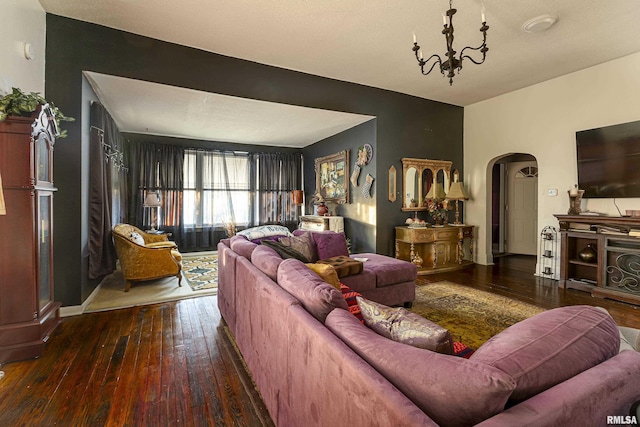 living room featuring a chandelier and dark hardwood / wood-style flooring