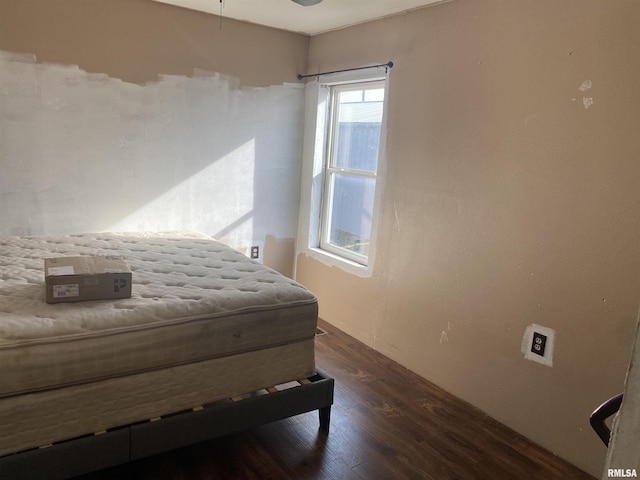 bedroom with dark hardwood / wood-style flooring