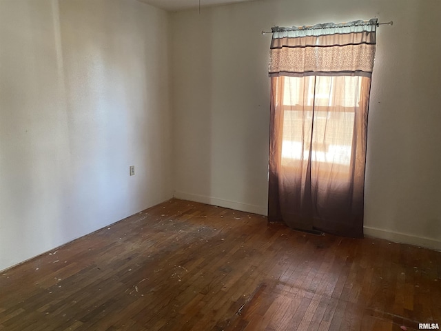 spare room featuring dark wood-type flooring