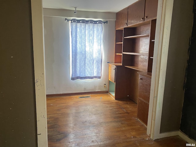 unfurnished bedroom with hardwood / wood-style flooring