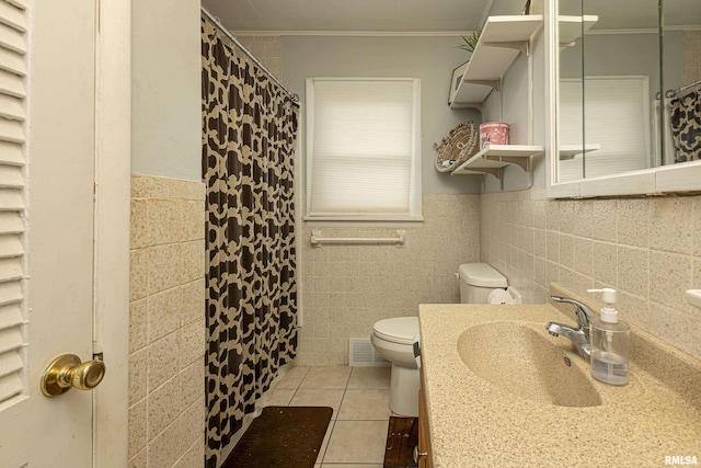 bathroom with crown molding, sink, and tile walls