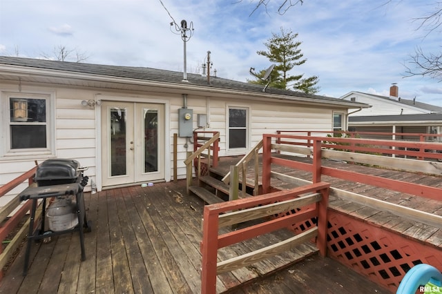 wooden terrace with area for grilling and french doors