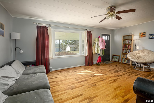 living area featuring light hardwood / wood-style floors and ceiling fan