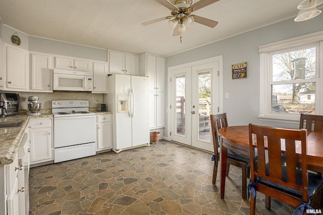 kitchen featuring white cabinetry, light stone counters, ceiling fan, white appliances, and french doors