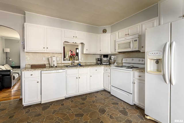 kitchen with white cabinetry, white appliances, and sink