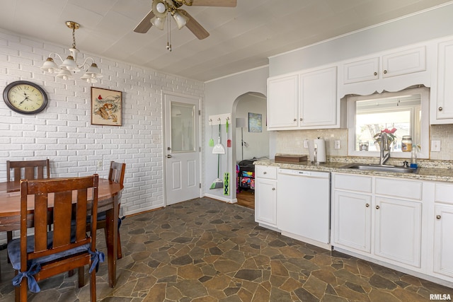 kitchen featuring white cabinets, light stone countertops, hanging light fixtures, and dishwasher