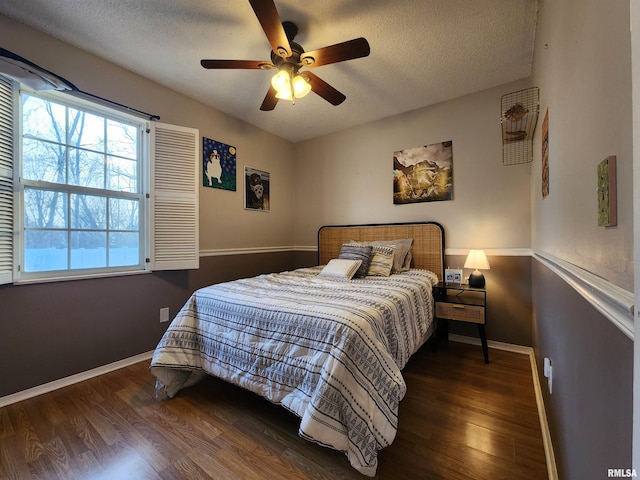 bedroom with wood-type flooring, a textured ceiling, and ceiling fan