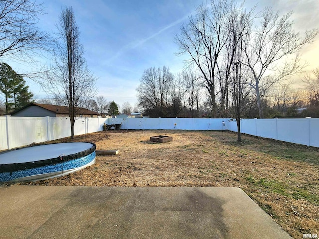 back of property featuring a hot tub, central AC unit, and a lawn