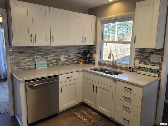 kitchen featuring white cabinetry, dishwasher, sink, and decorative backsplash