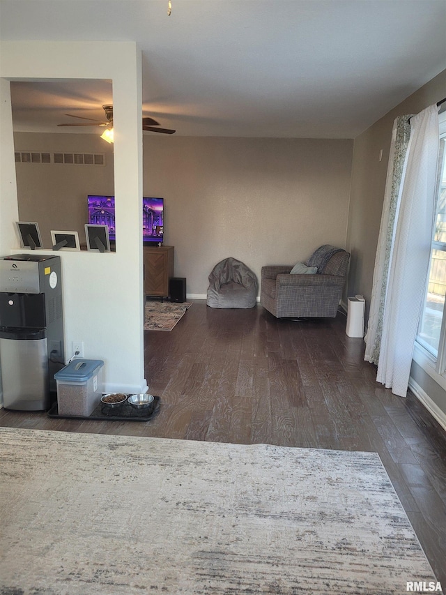 interior space featuring dark wood-type flooring and ceiling fan