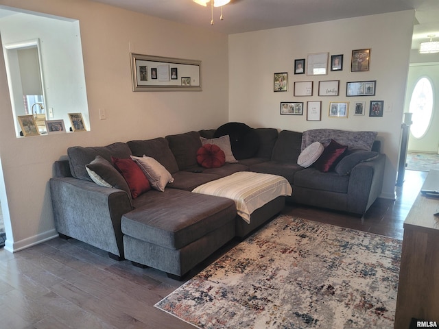 living room with dark hardwood / wood-style floors and ceiling fan