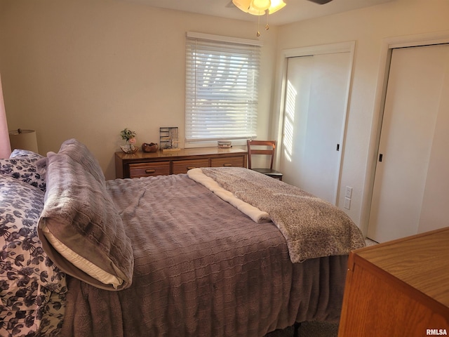 bedroom with multiple closets and ceiling fan