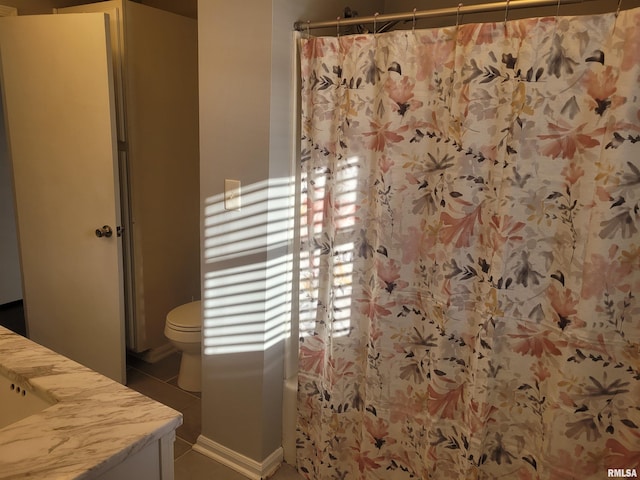 bathroom featuring vanity, walk in shower, and toilet