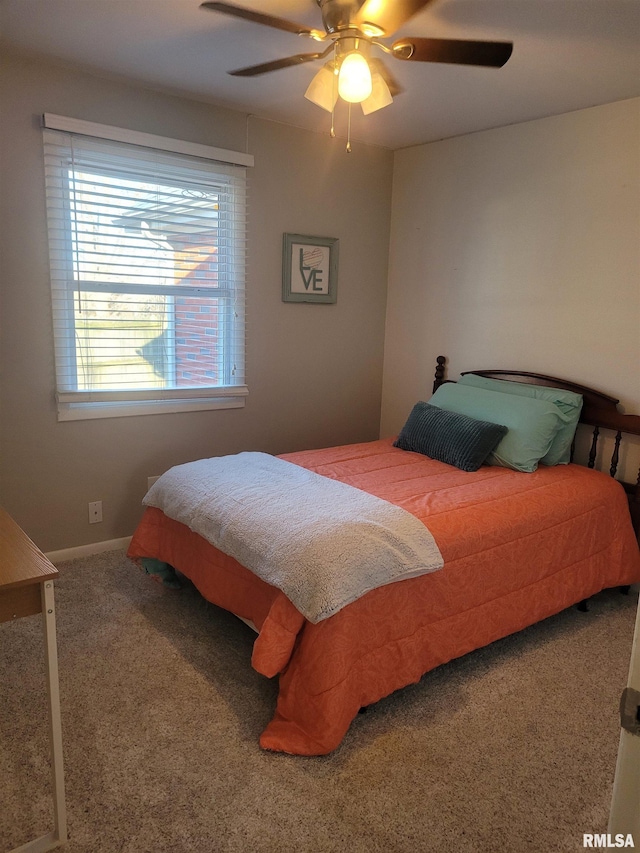 bedroom with ceiling fan, baseboards, and carpet floors
